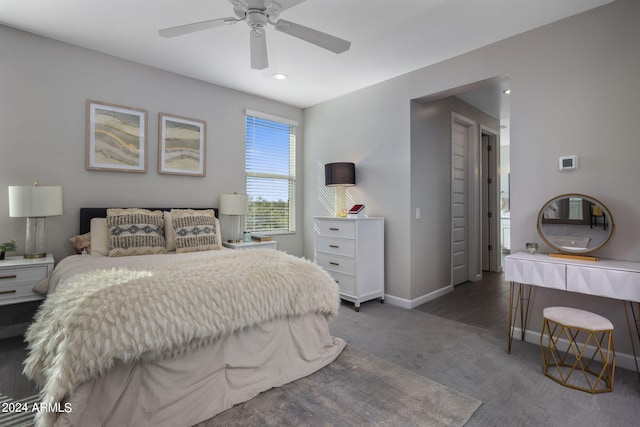 bedroom with ceiling fan and dark colored carpet