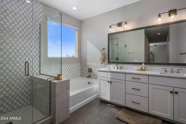 bathroom with tile patterned floors, independent shower and bath, and double vanity