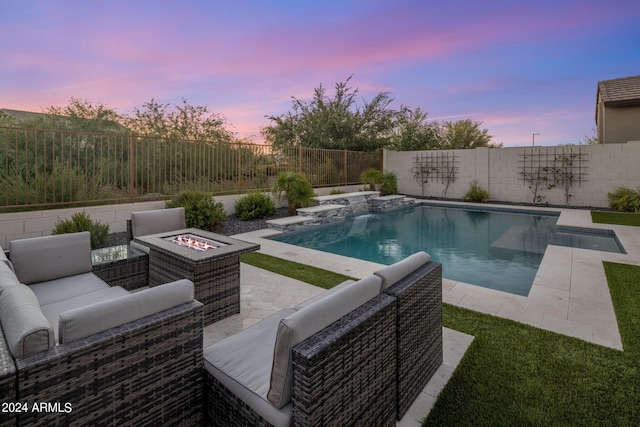 pool at dusk with an outdoor living space with a fire pit and a patio