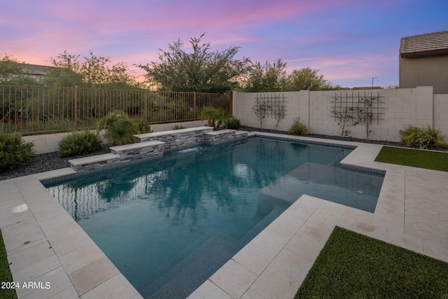 view of pool at dusk