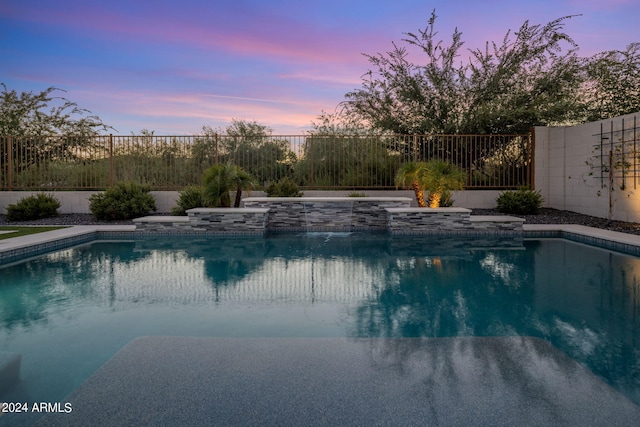 view of pool at dusk