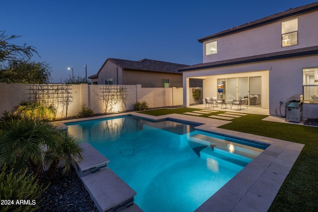 view of swimming pool featuring a patio and a grill