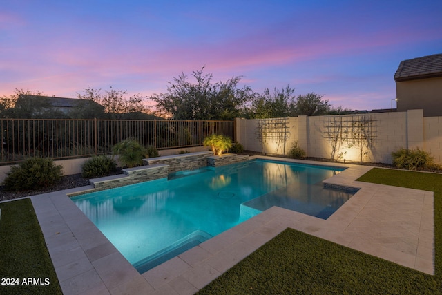 view of pool at dusk