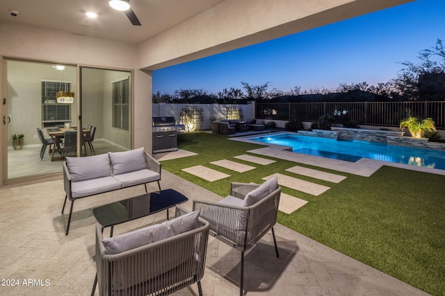 pool at dusk featuring area for grilling, a patio, and outdoor lounge area