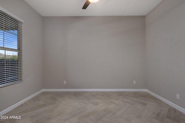 spare room featuring ceiling fan and light parquet floors