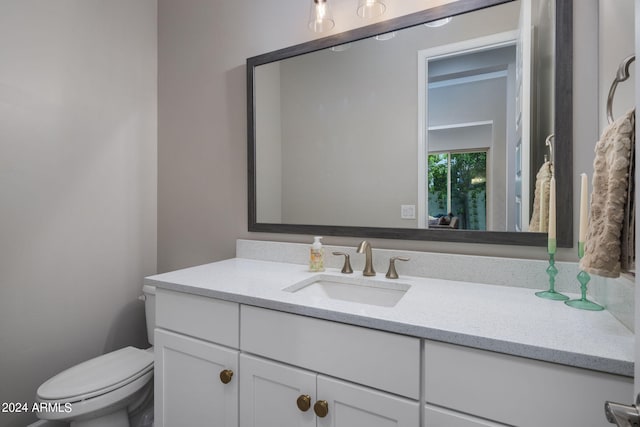 bathroom featuring toilet and vanity