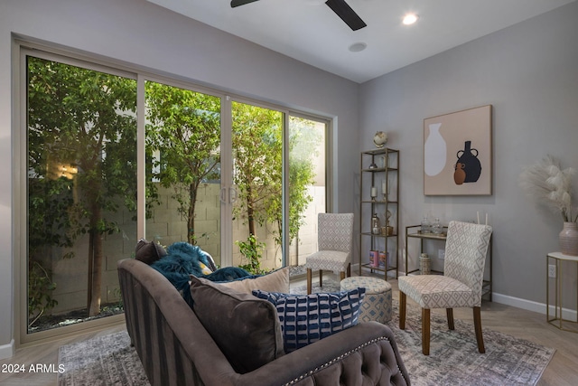 living area featuring ceiling fan and light hardwood / wood-style floors