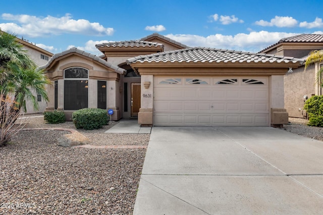 9631 E Palm Ridge Dr, Scottsdale, AZ 85260 - mediterranean / spanish-style house featuring driveway, a garage, stucco siding, and a tiled roof