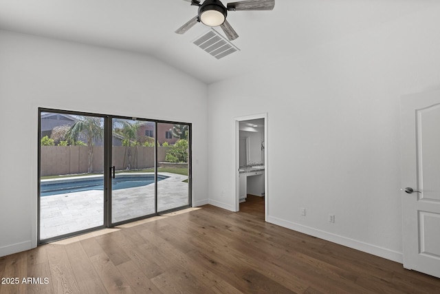 9631 E Palm Ridge Dr, Scottsdale, AZ 85260 - unfurnished bedroom featuring access to exterior, vaulted ceiling, wood finished floors, baseboards, and ensuite bathroom