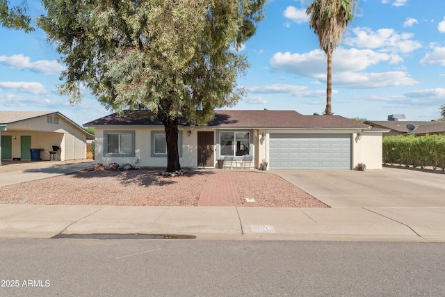 single story home with stucco siding, driveway, and an attached garage