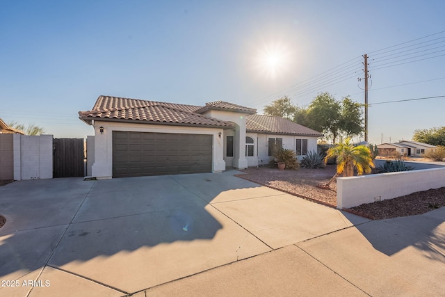 mediterranean / spanish home featuring a garage