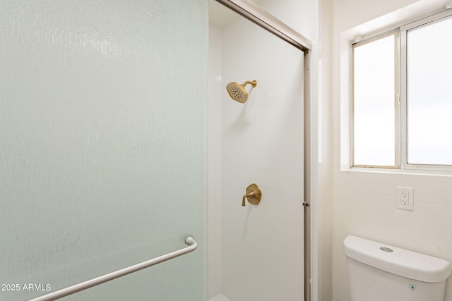 bathroom featuring toilet and a shower