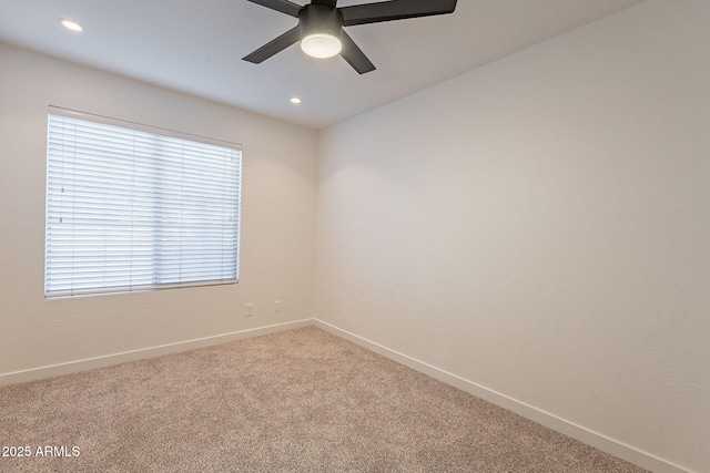 spare room with carpet and ceiling fan