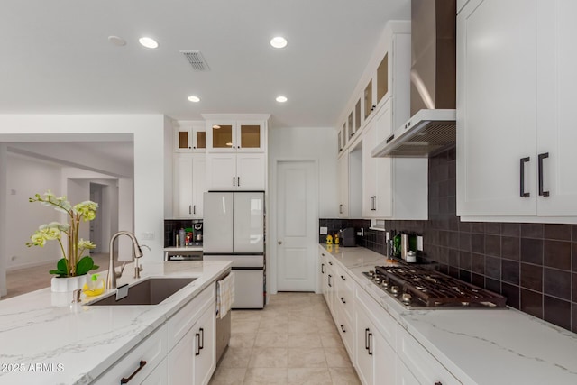 11015 E Texas Ave, Mesa, AZ 85212 - kitchen featuring wall chimney range hood, stainless steel appliances, tasteful backsplash, white cabinets, and glass insert cabinets