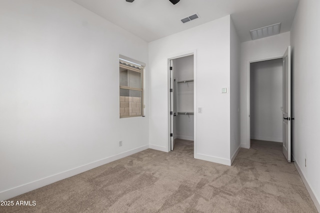 11015 E Texas Ave, Mesa, AZ 85212 - unfurnished bedroom featuring light carpet, a spacious closet, a closet, and ceiling fan