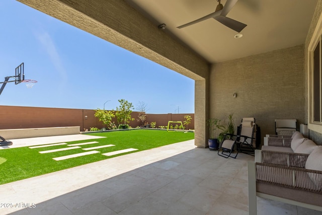 11015 E Texas Ave, Mesa, AZ 85212 - fenced backyard featuring a patio area, a ceiling fan, and an outdoor living space