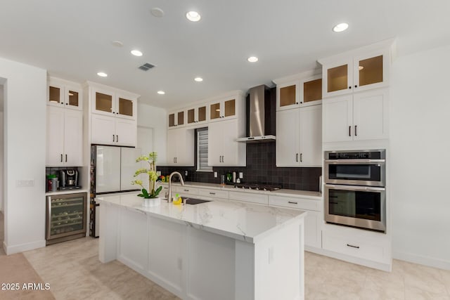 11015 E Texas Ave, Mesa, AZ 85212 - kitchen featuring wine cooler, wall chimney range hood, gas cooktop, tasteful backsplash, and recessed lighting