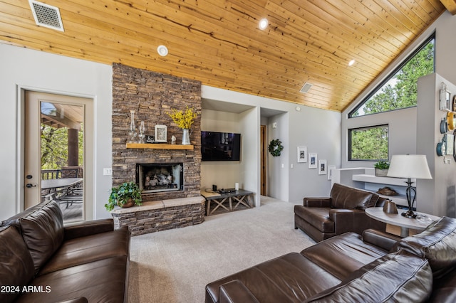 carpeted living room with a healthy amount of sunlight, a stone fireplace, high vaulted ceiling, and wood ceiling