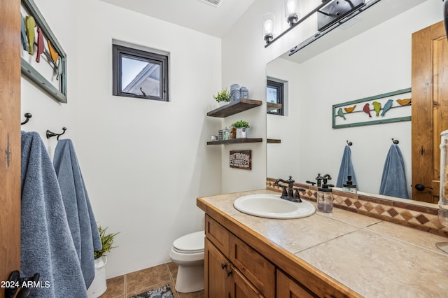 bathroom with tile patterned floors, vanity, and toilet