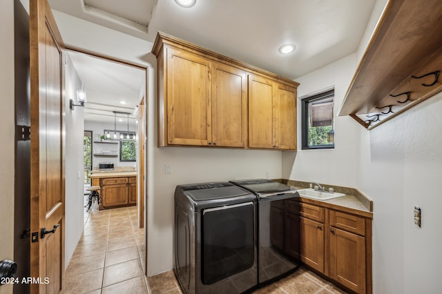 washroom featuring light tile patterned floors, washing machine and dryer, recessed lighting, a sink, and cabinet space