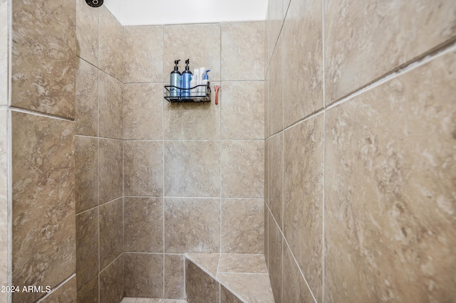 interior details with a tile shower