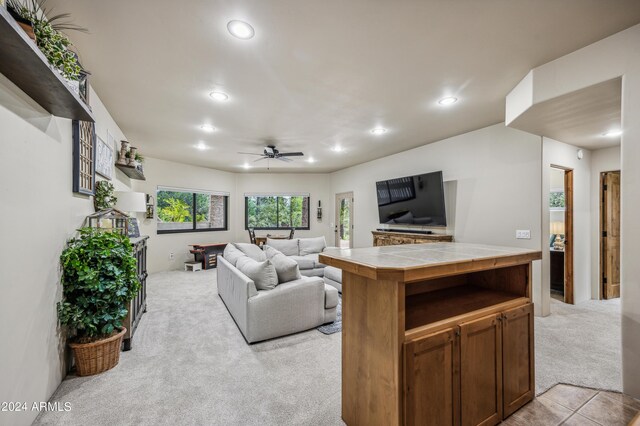 living room with light carpet and ceiling fan