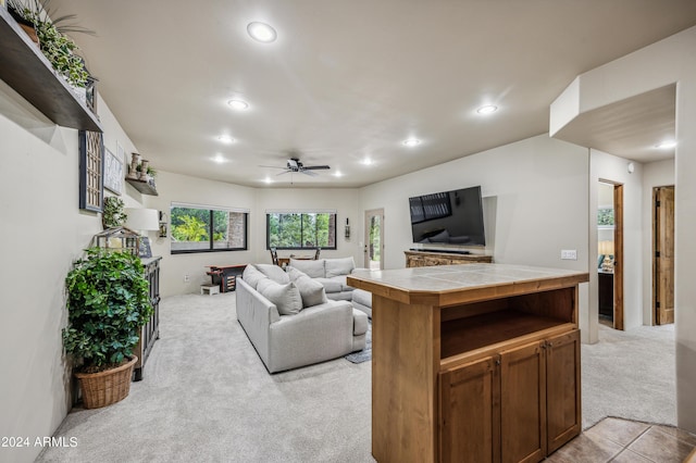 living area with light carpet, ceiling fan, light tile patterned floors, and recessed lighting