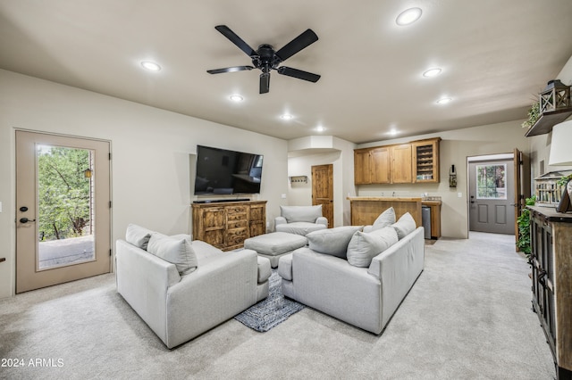 carpeted living room featuring ceiling fan and a wealth of natural light