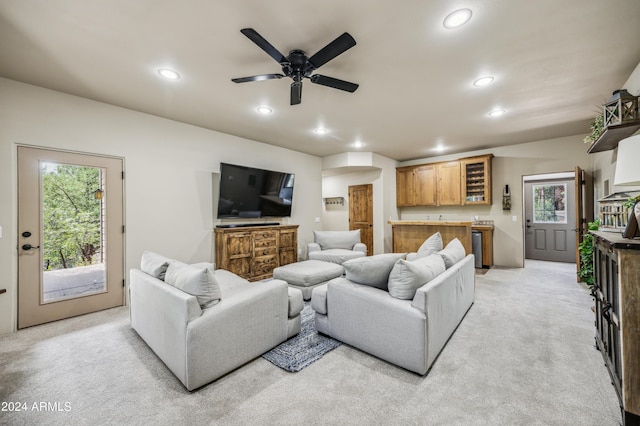 living area featuring light carpet, plenty of natural light, indoor wet bar, and recessed lighting