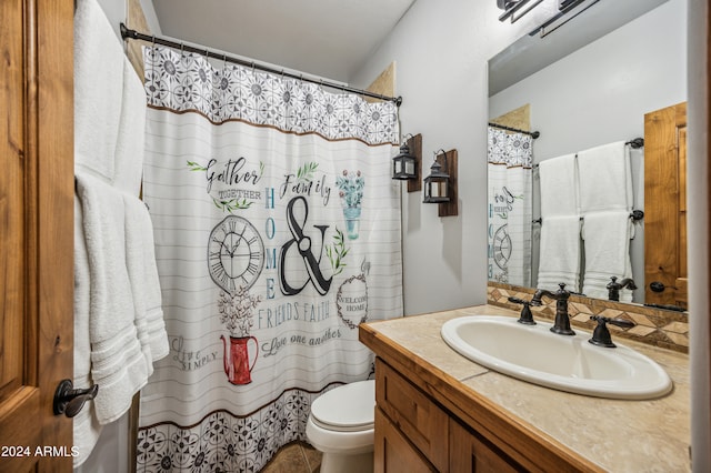 bathroom featuring toilet and vanity