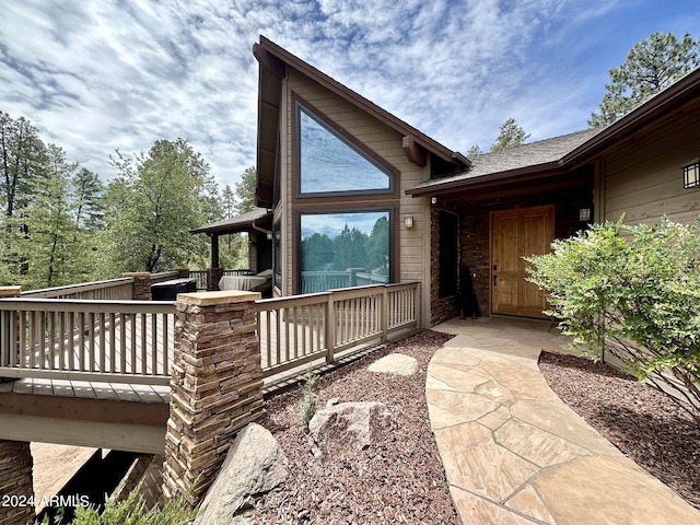 view of property exterior featuring a wooden deck