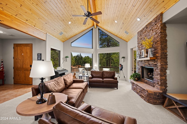 carpeted living room with wooden ceiling, a stone fireplace, high vaulted ceiling, and ceiling fan