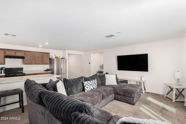 living room featuring light carpet