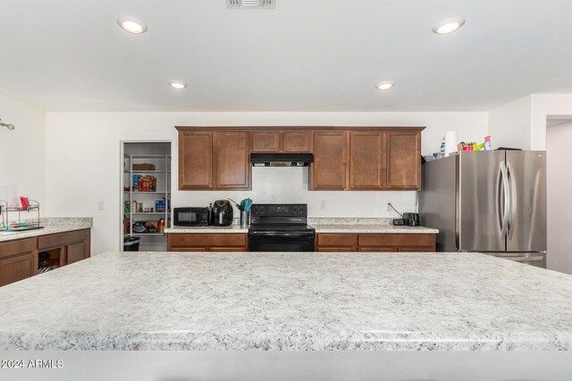 kitchen with a kitchen island and black appliances