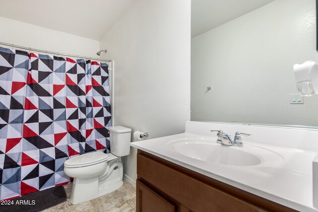 bathroom with walk in shower, vanity, and toilet