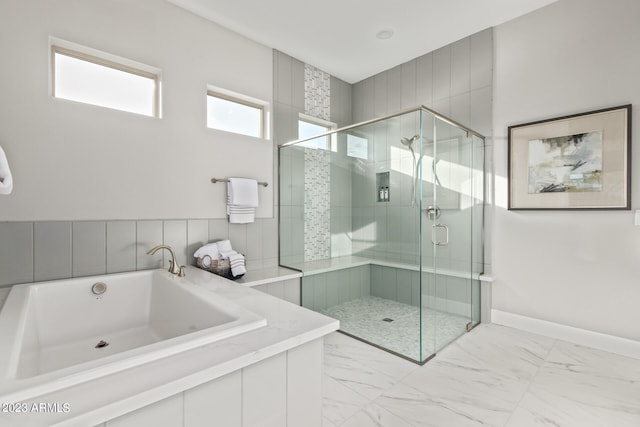 bathroom featuring separate shower and tub