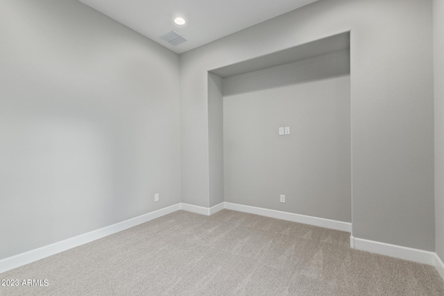 spare room featuring light colored carpet