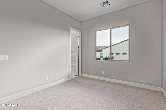 unfurnished room featuring light colored carpet