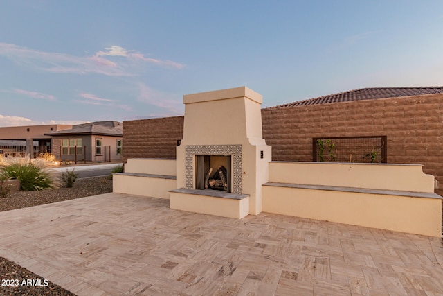 view of patio with an outdoor fireplace