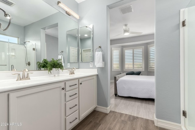 bathroom with vanity, hardwood / wood-style flooring, ceiling fan, and walk in shower