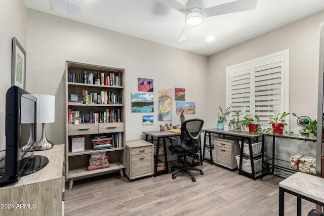 office area with light wood-type flooring and ceiling fan