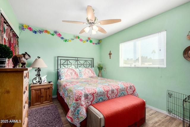 bedroom with wood-type flooring and ceiling fan