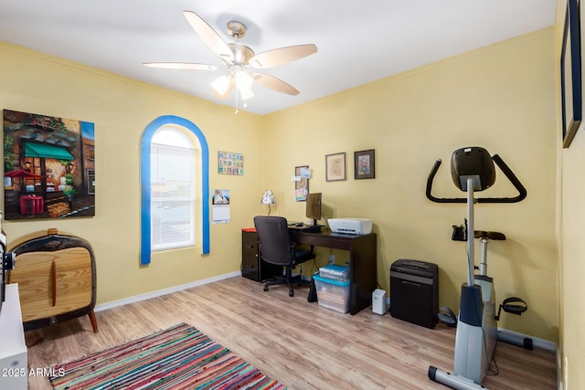 office with light wood-type flooring and ceiling fan