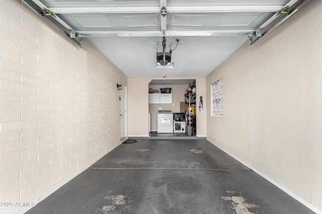 garage featuring washing machine and dryer and a garage door opener