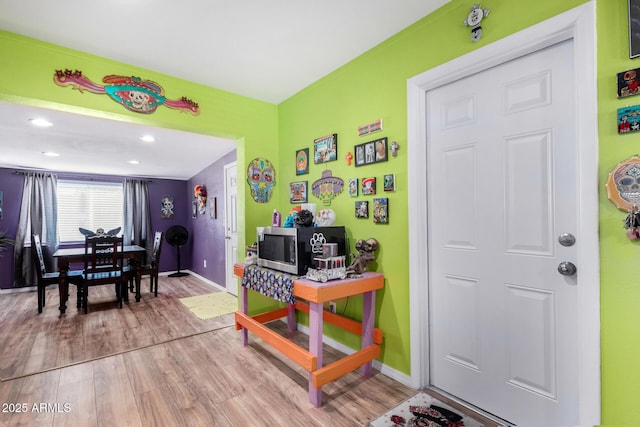 game room with light hardwood / wood-style floors