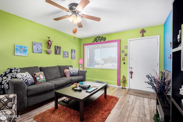 living room featuring light hardwood / wood-style flooring and ceiling fan