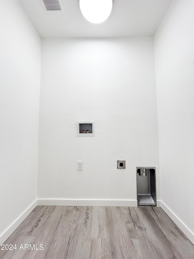 laundry area featuring hookup for an electric dryer, hookup for a washing machine, and light hardwood / wood-style floors