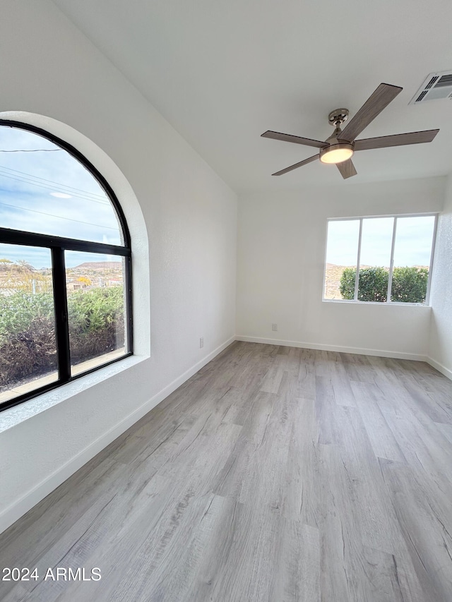 unfurnished room featuring ceiling fan and light hardwood / wood-style flooring