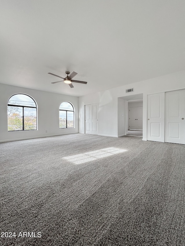 empty room featuring ceiling fan and carpet floors