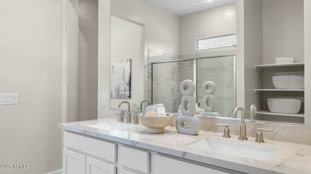 bathroom featuring double vanity, a sink, and a marble finish shower